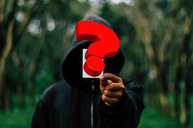 hacker holding a question mark