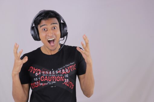 A man wearing headphones and screaming